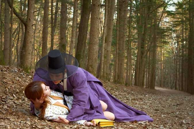 Boong-Do catches Hee-Jin as she faints