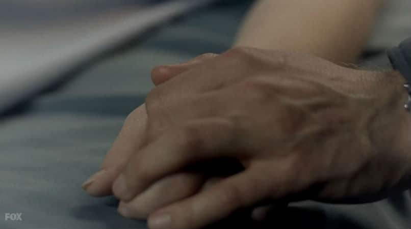 Mulder holds Scully's hand in past the x files