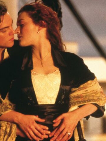 titanic 1997 anniversary review featured image with Leonardo Dicaprio and Kate Winslet about to kiss at sunset.