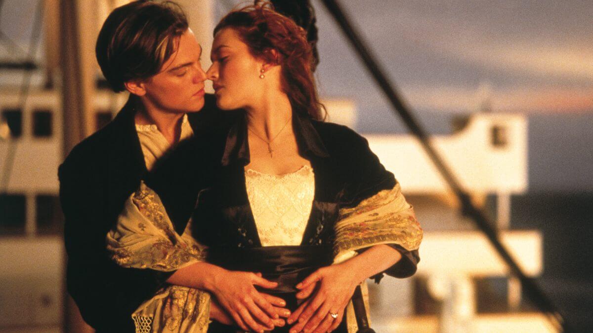 titanic 1997 anniversary review featured image with Leonardo Dicaprio and Kate Winslet about to kiss at sunset.