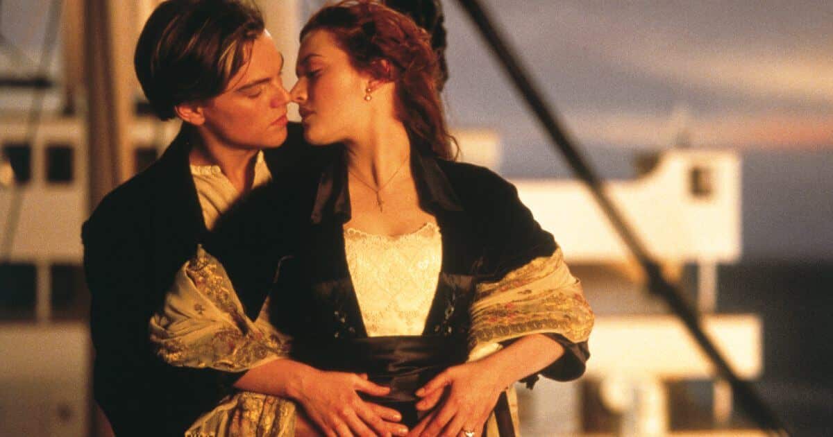 titanic 1997 anniversary review featured image with Leonardo Dicaprio and Kate Winslet about to kiss at sunset.