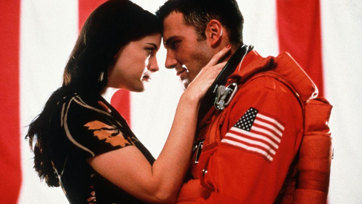 Liv Tyler and Ben Affleck in Armageddon with an American flag background