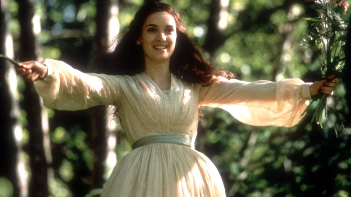 Jo March in Little Women 1994 movie wearing a white dress and blue ribbon