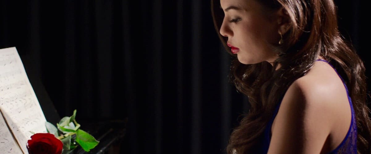 Janel Parrish in Until We Meet Again playing the piano