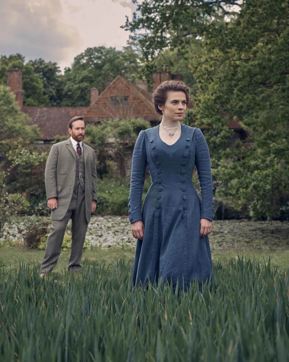 Howards End promo image of Matthew Macadyen and Hayley Atwell outside on the grass with a house behind them.