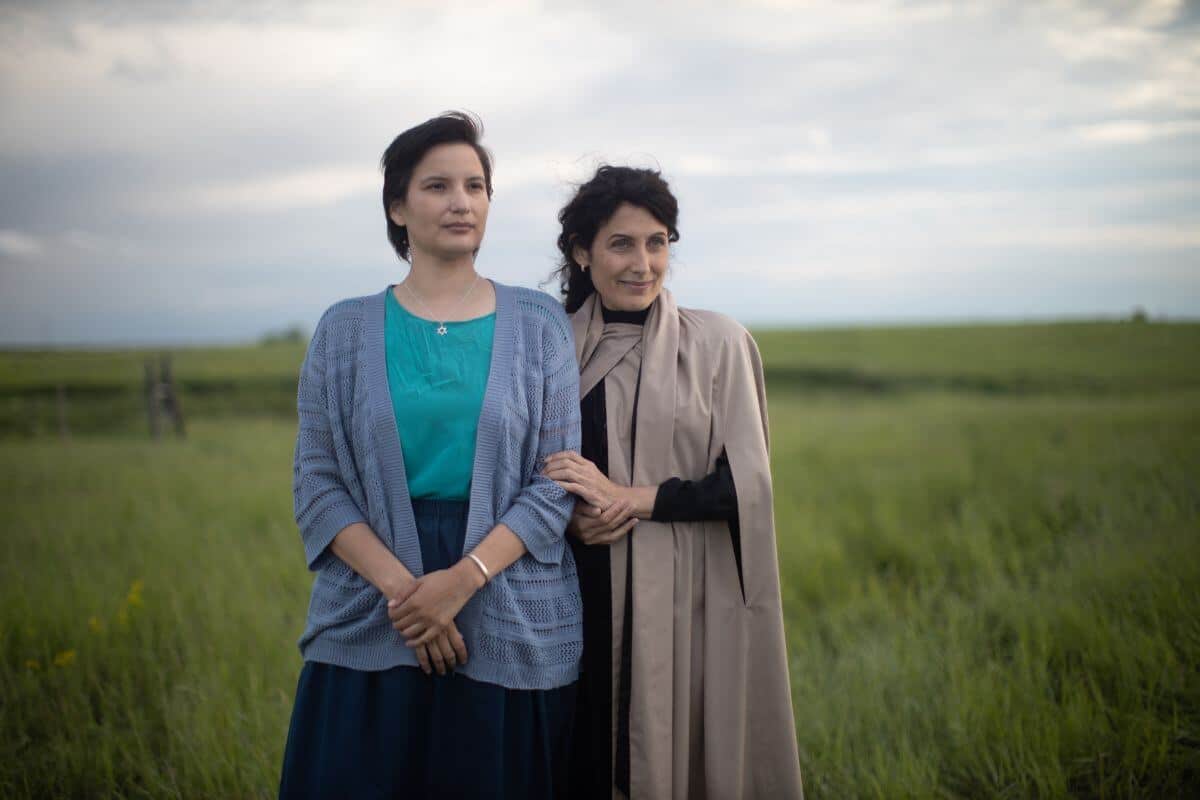 Little Bird promo image with Darla Contois and Lisa Edelstein standing in a field close together.