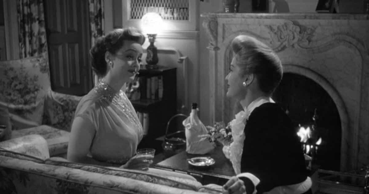 Bette Davis and Miriam Hopkins in Ending of Old Acquaintance sharing a drink.