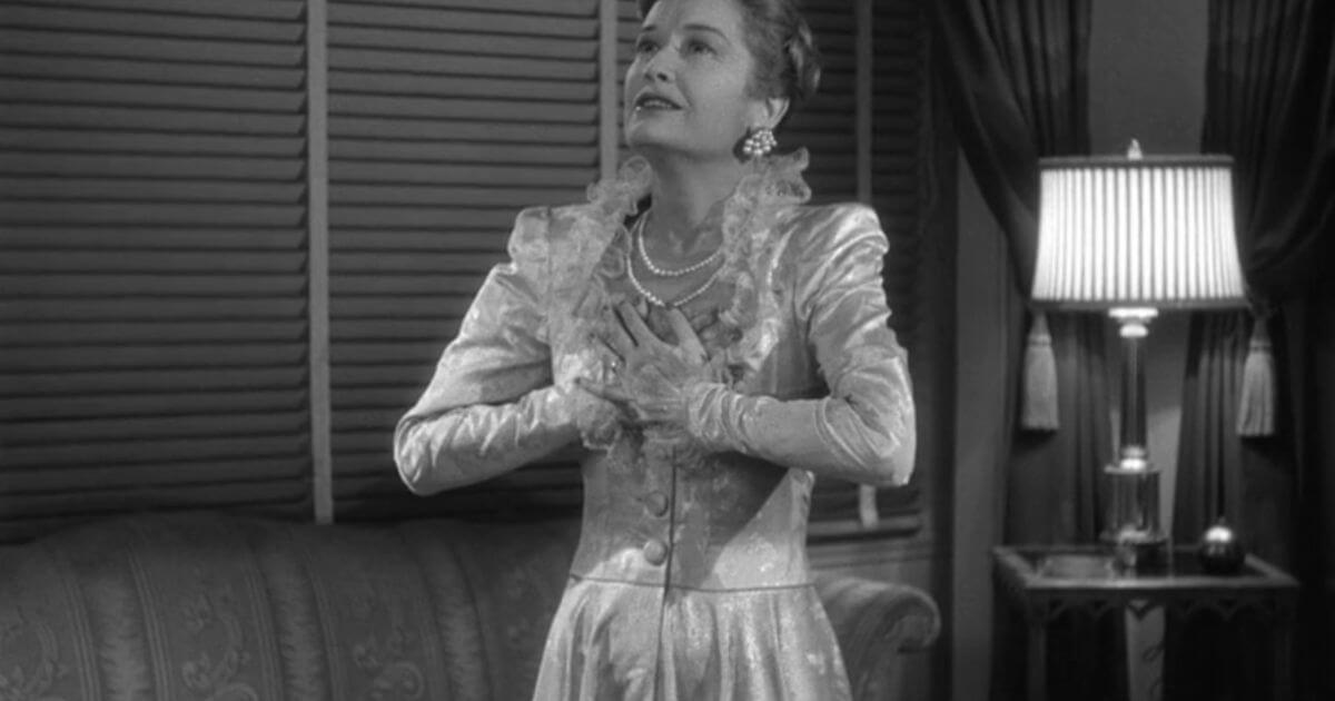 Miriam Hopkins in Old Acquaintance wearing a fancy white dress.